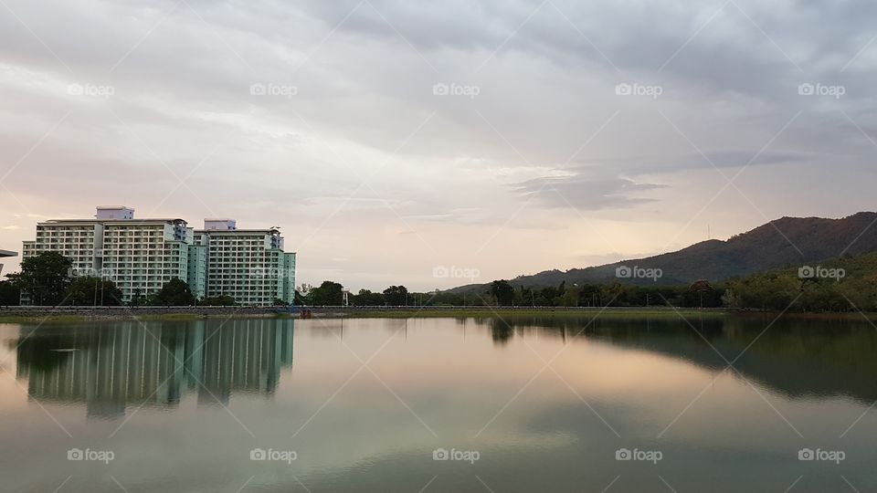 Buildings beside river and mountain