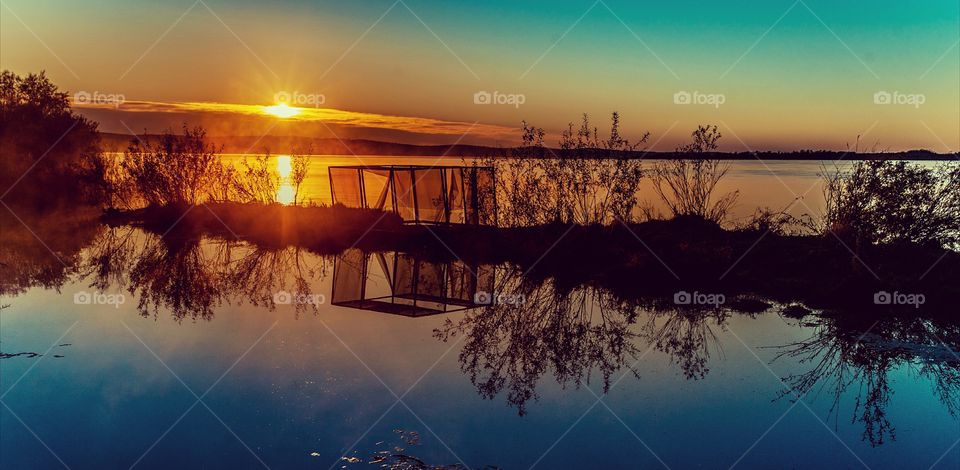 Reflection on idyllic lake at sunset