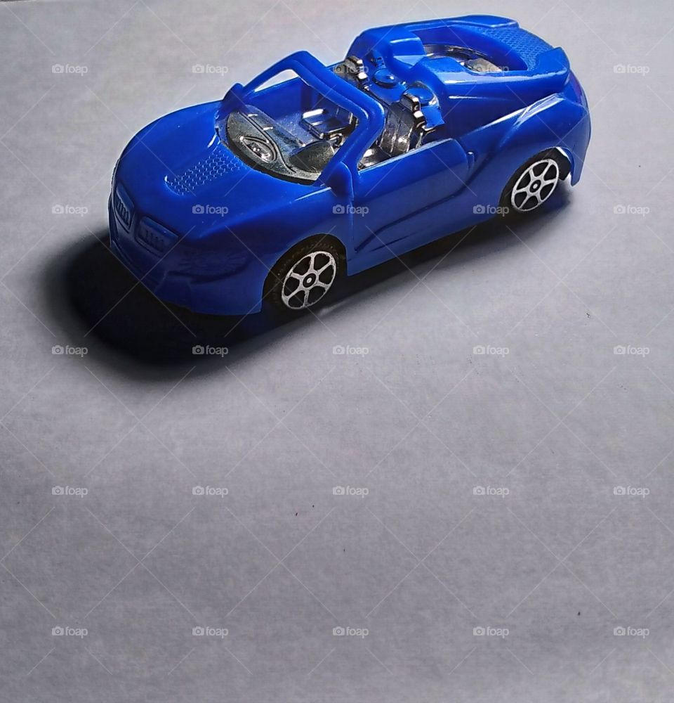 A toy car with a white background.