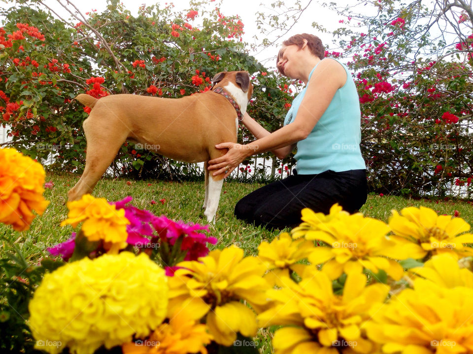 Woman with dog in backyard