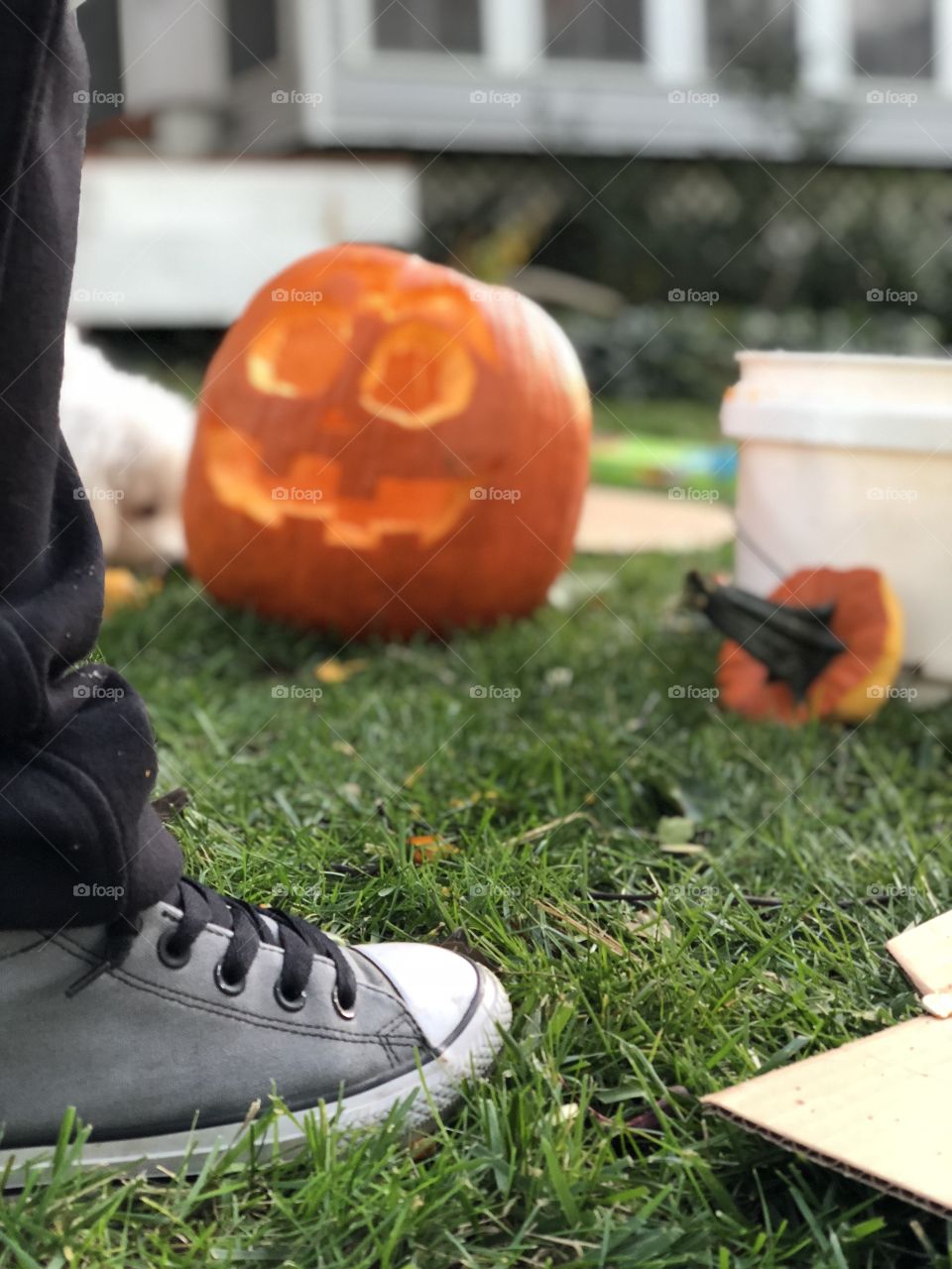 Carving pumpkins to create jack-o-lanterns for Halloween in Converse shoes - love my Chucks
