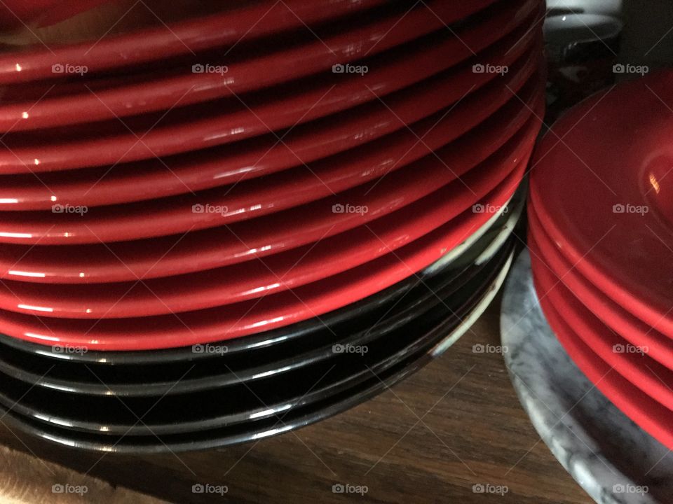 Two stacks of red plates