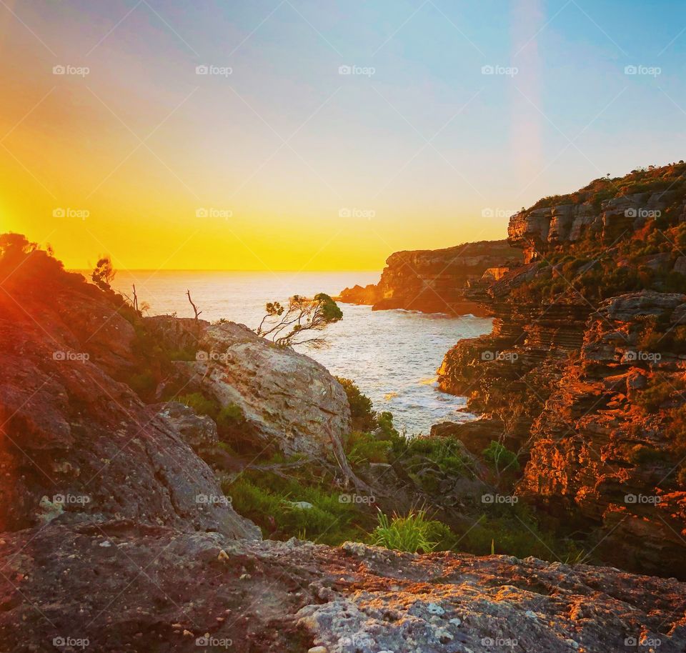 Sunrise at the ocean cliff edge 