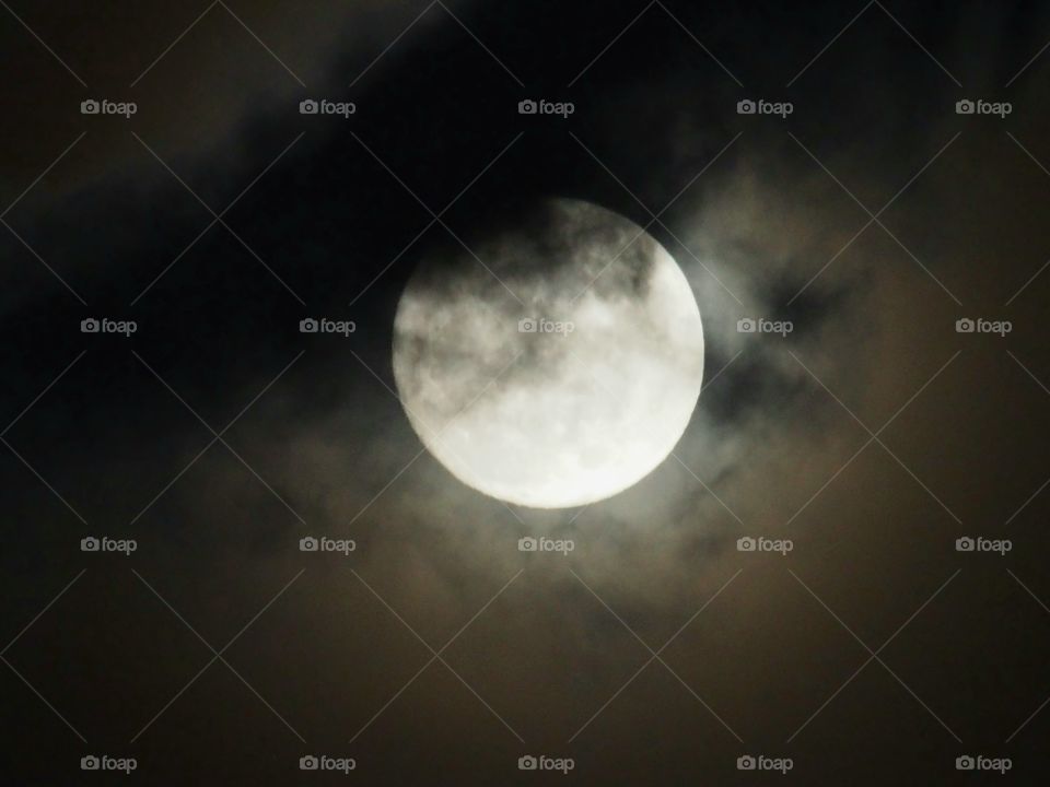 Moon and clouds in natural black sky background