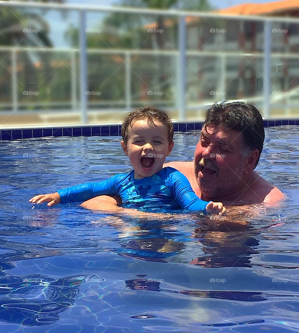 Grandfather and boy in the pool
