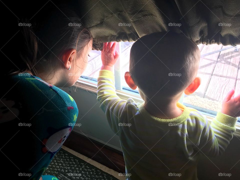 Children peering out window sisters snowbound illness 