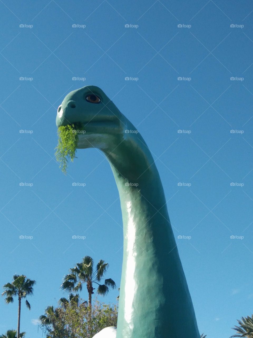 Cute dinosaur eating plants at Disney