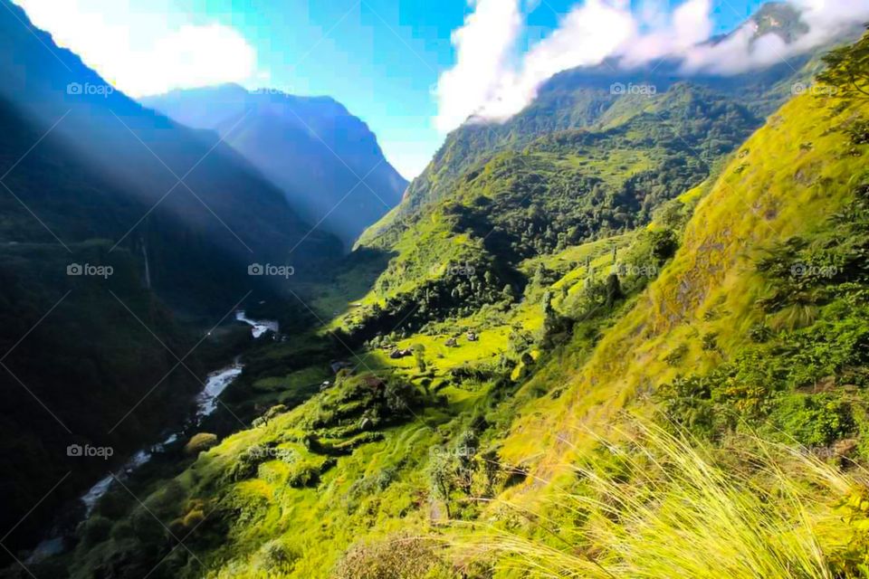 A valley is lit up by a ray of sunshine. Taken on the Dhaulagiri Circuit Trek in Nepal.