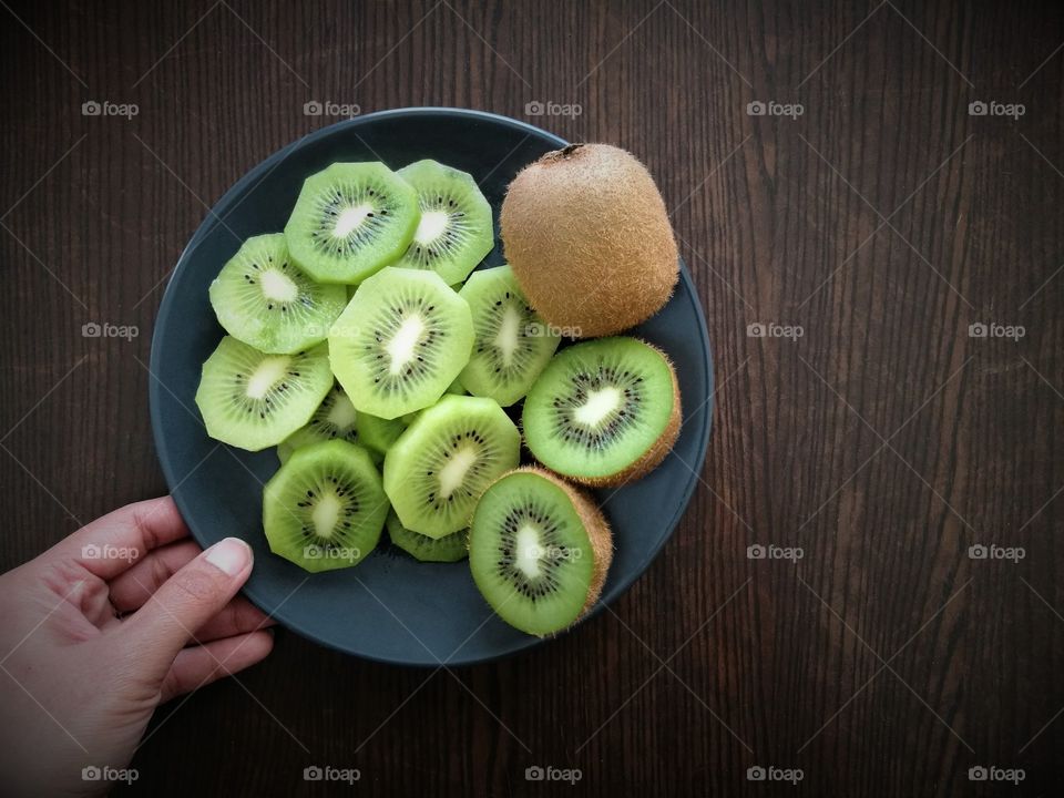 Kiwi fruit on wood table. Healthy and diet natural meal.