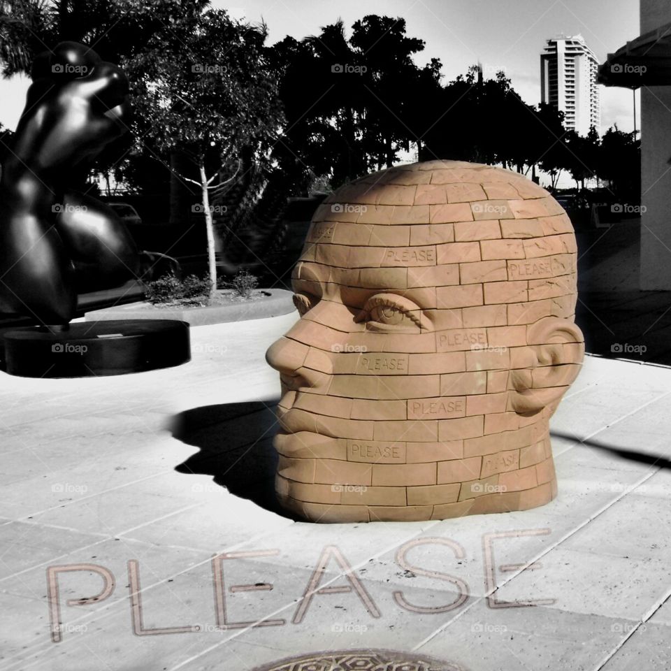 Please sculpture. James Tyler's brickhead Please Stop sculpture outside 4 Midtown Miami, Florida