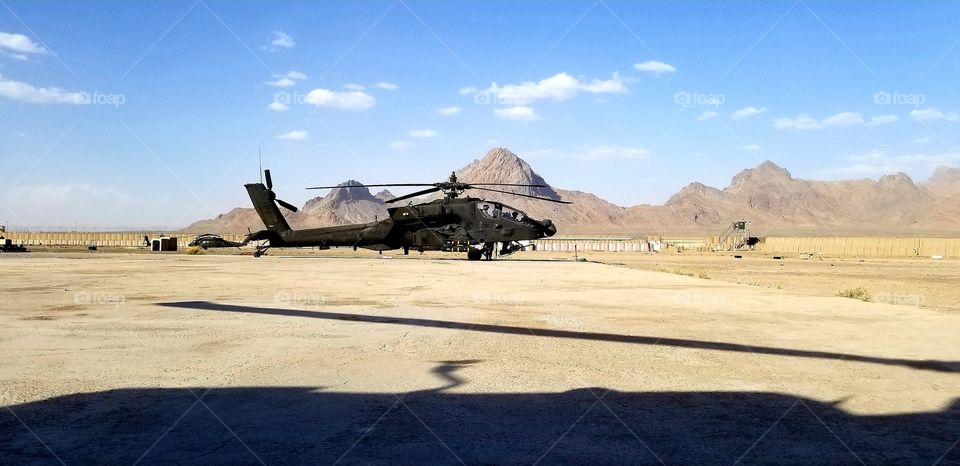 An AH-64 Apache waiting patiently to go out on mission in the mountains of Afghanistan.