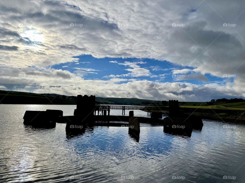 Sunshine trying to break through over a reservoir 