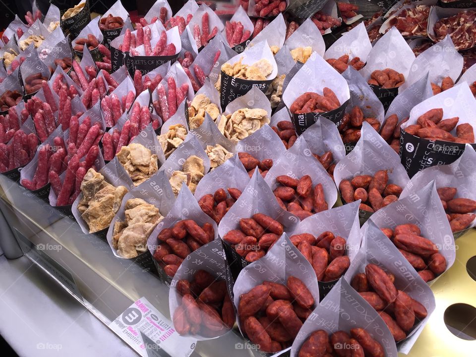 Different types of chorizos and other pork meat sold in paper cones