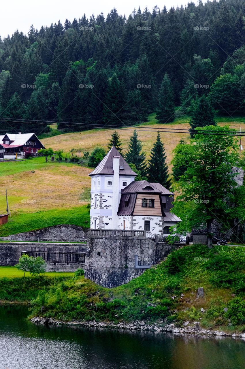 Building by lake at mountains