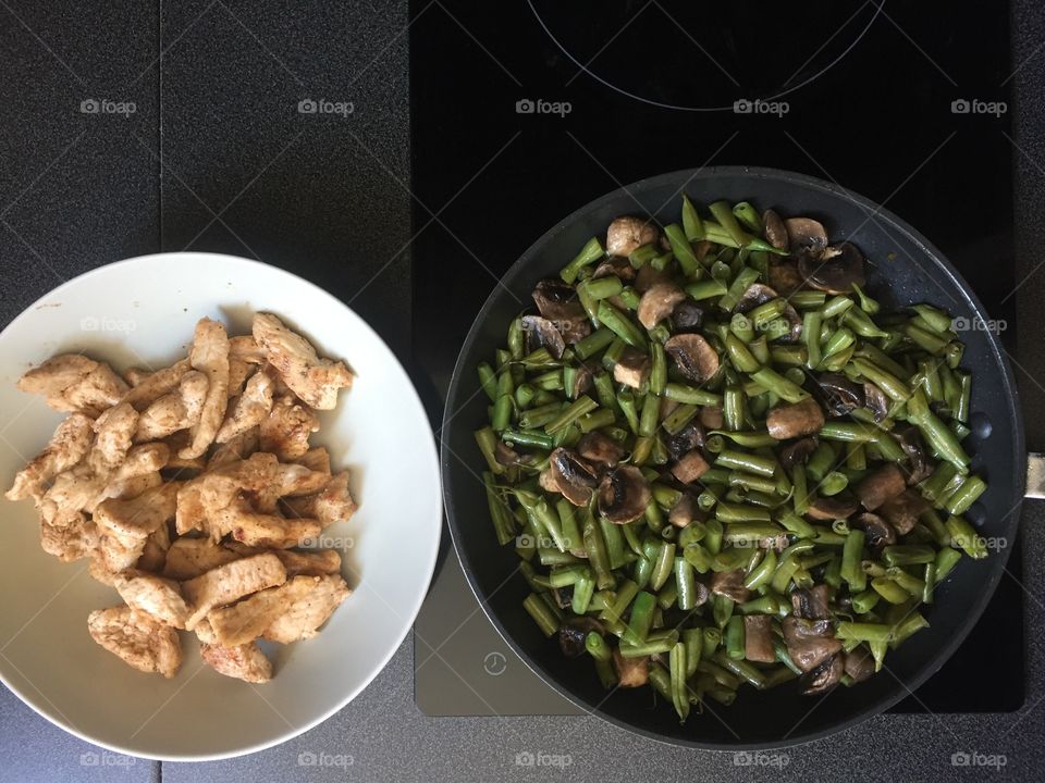 Homemade food. Chicken, green beans with mushrooms