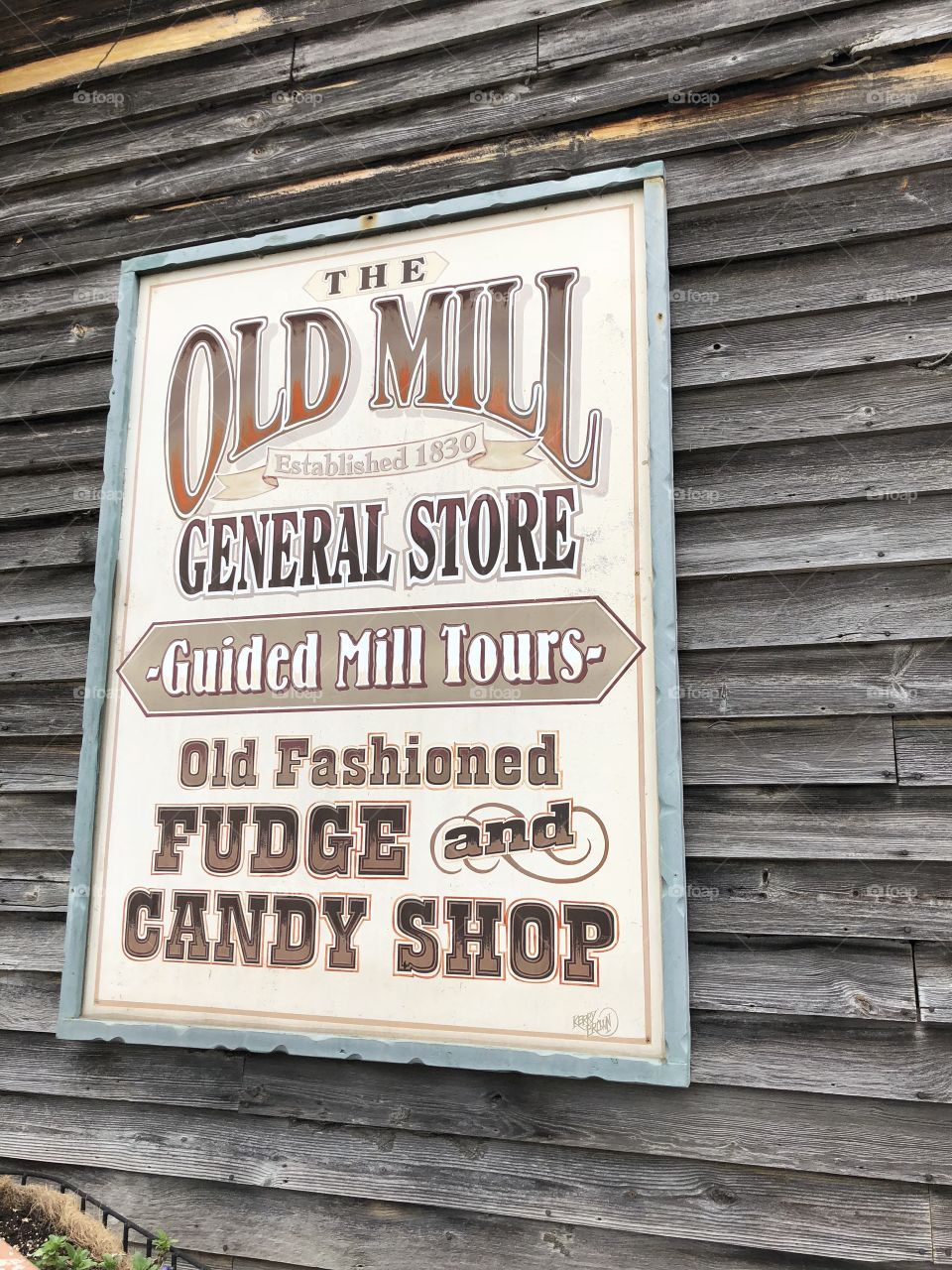 Sign on a very Old Mill in Tennesee that is on a General Store touting if candy and fudge!