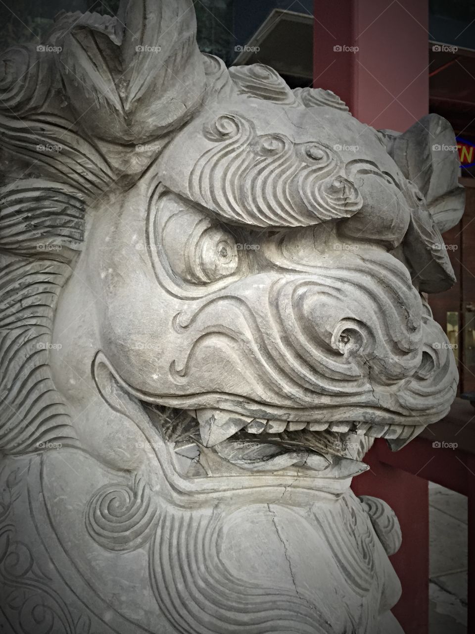 Eyes of a Dragon. A stone dragon statue sitting outside of a Japanese steak house. 