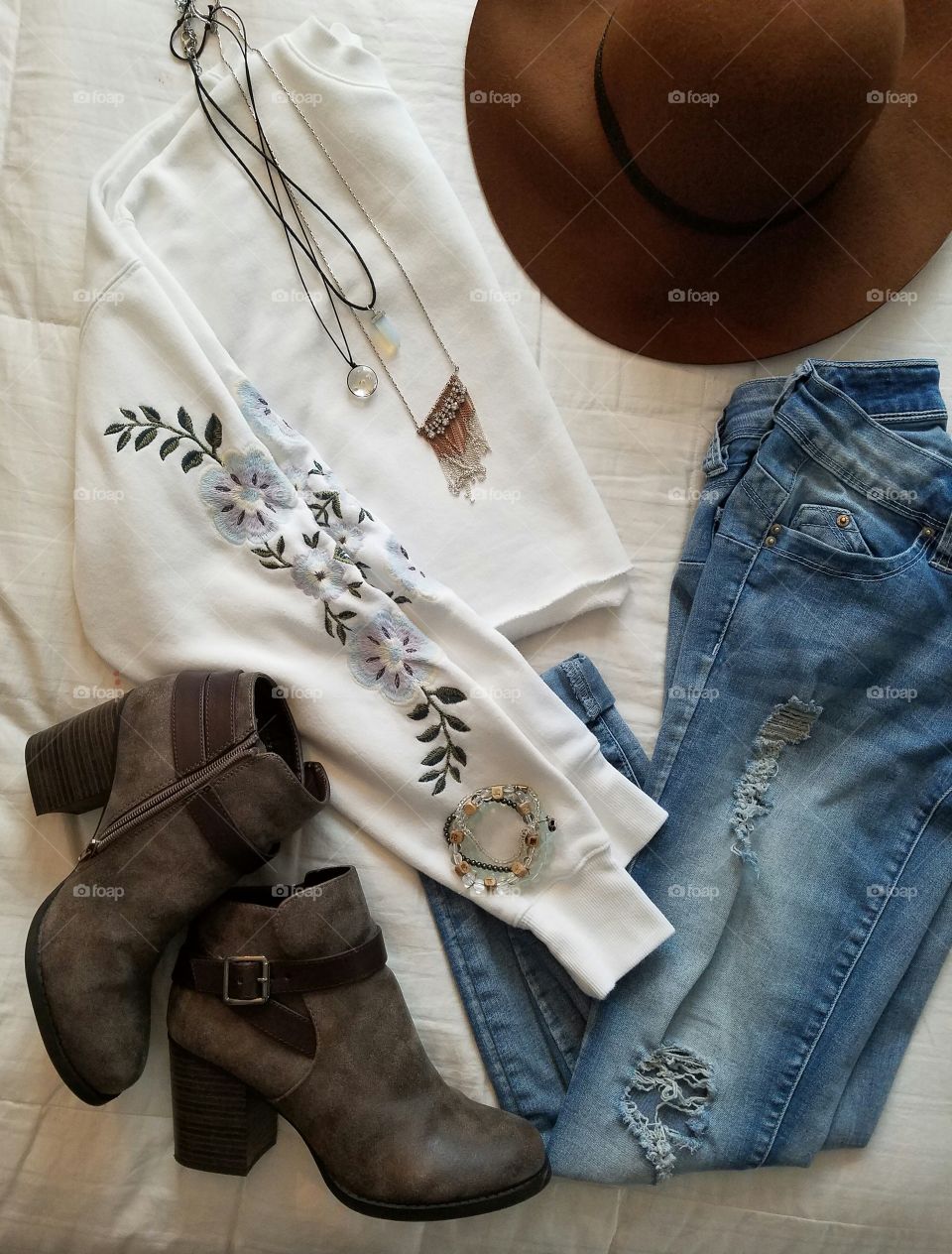 flat lay clothes jeans shirt hat boots