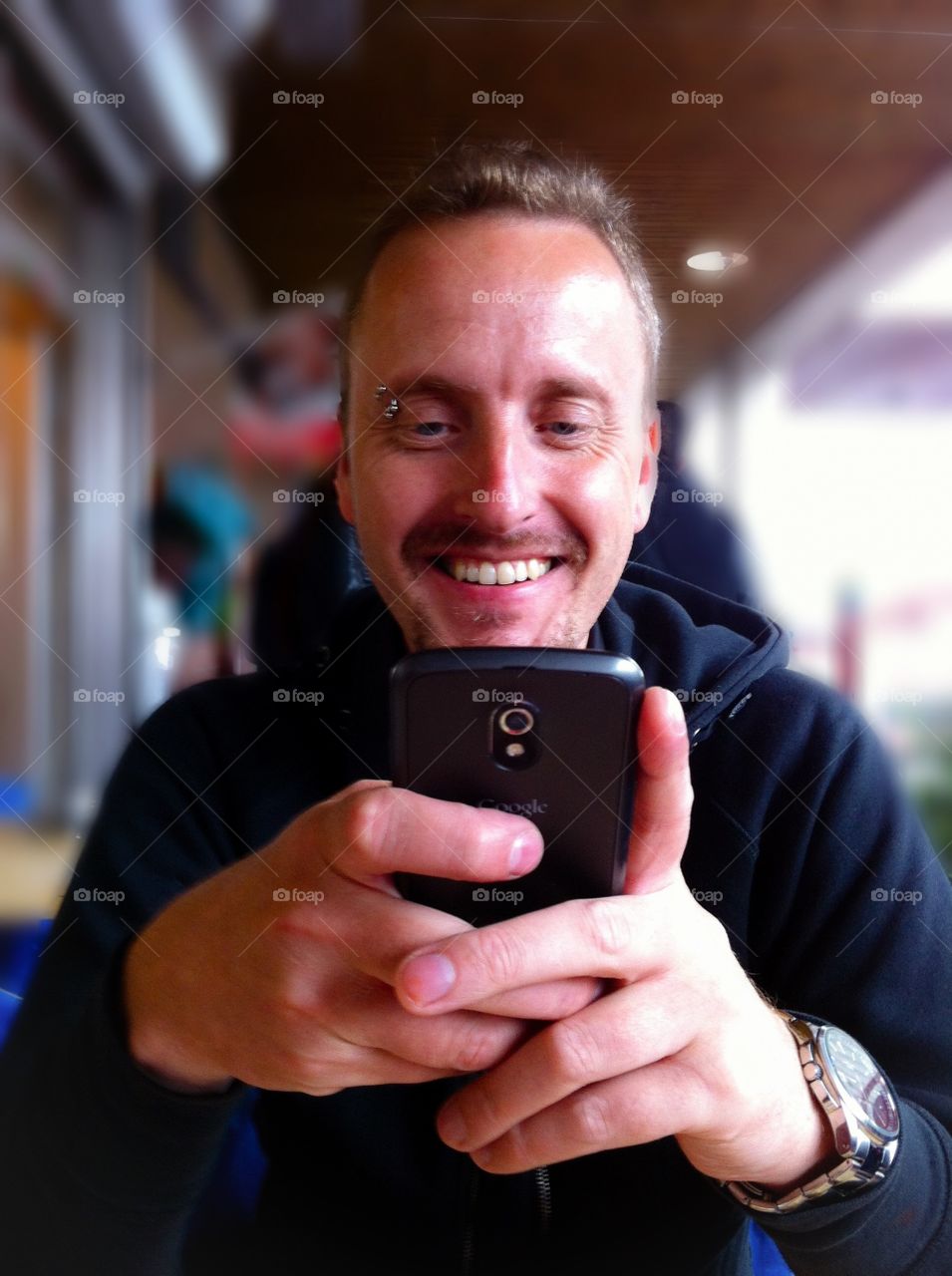 Portrait of a man texting on cellphone