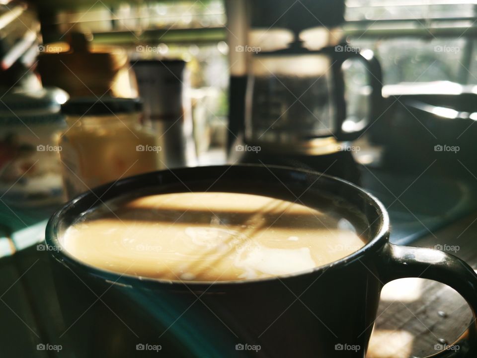 Creamy coffee in morning light