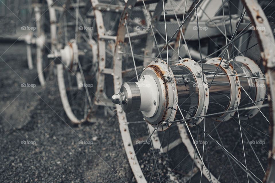 row of metal wheels,  wide angle view