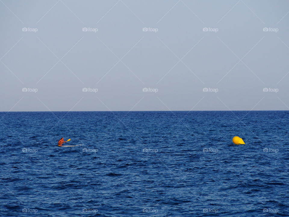Surfer paddling in the sea