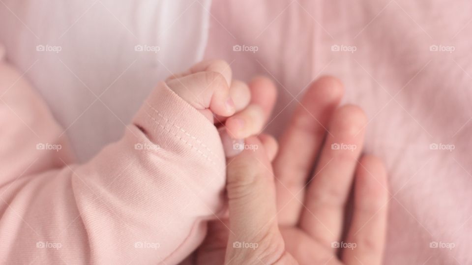 Mother and baby girl hands 