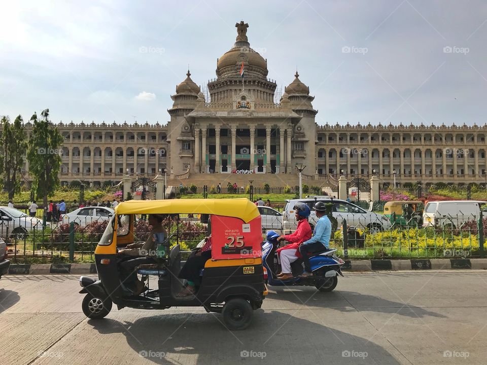 Auto riksha and scooter in front of Vidhana Soudha in Bengaluru, Karnataka, India 