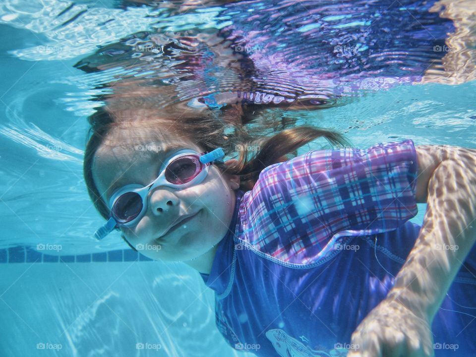 Girl swimming in swimming pool