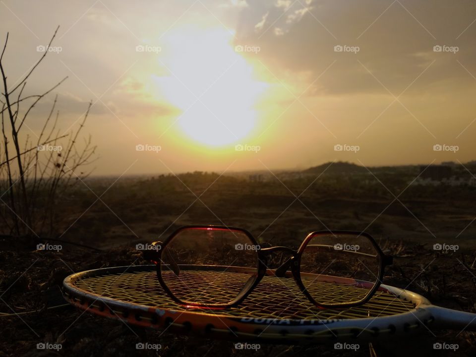 sunset with sunglasses by playing racket full fun