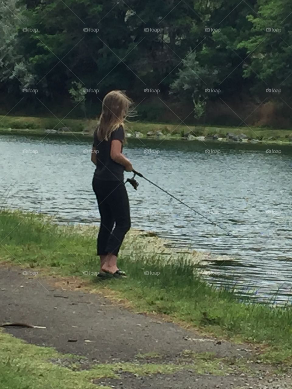 Blond haired girl fishing