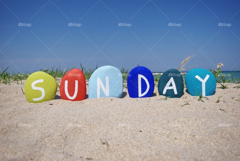 Sunday, seventh day of the week on colourful stones
