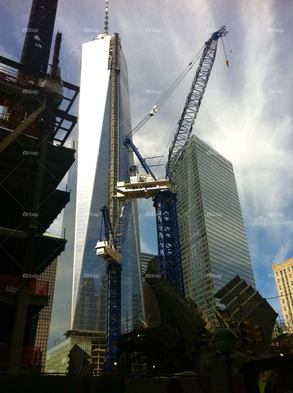 Rising glass. The Fulton Street transit hub rises alongside the Freedom Tower