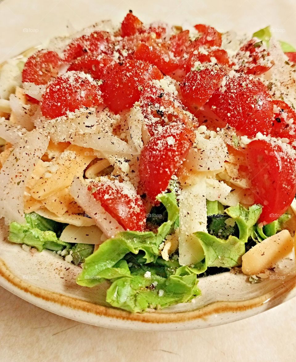 colorful green salad with tomatoes and cheese