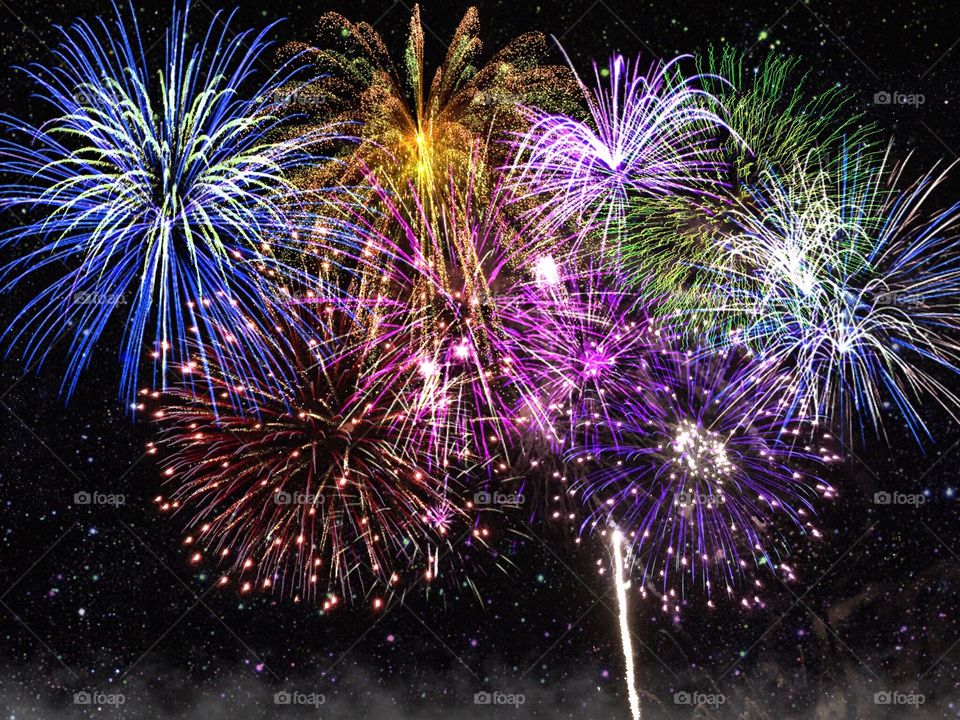 Multicolored fireworks lighting up the night sky in a dazzling display.