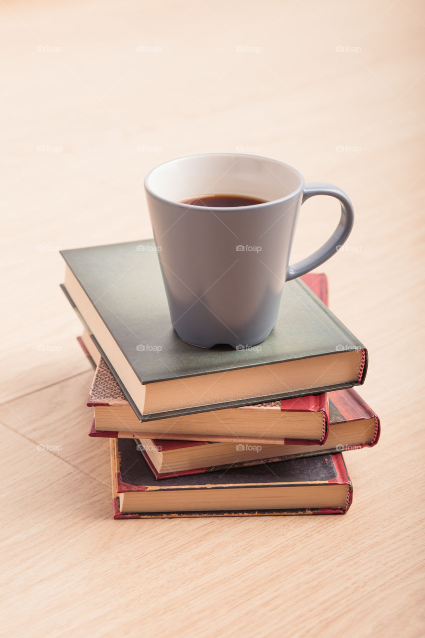 A few books with cup of coffee and cookies on wooden floor. Time for relax. Spending leisure time on reading. Cozy and comfortable. Learning from books 📖Studying for the next exam 😌