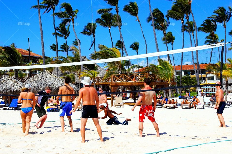 People playing beach volleyball 