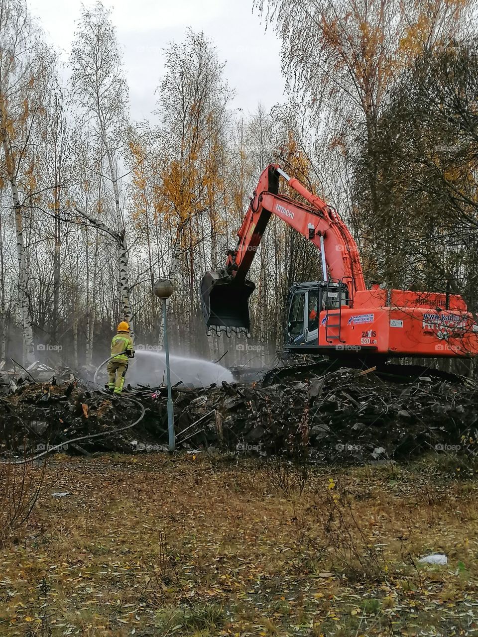 The big building burned down. A firefighter extinguishing a fire.