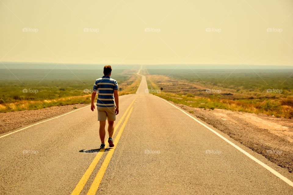Man walking at desert road