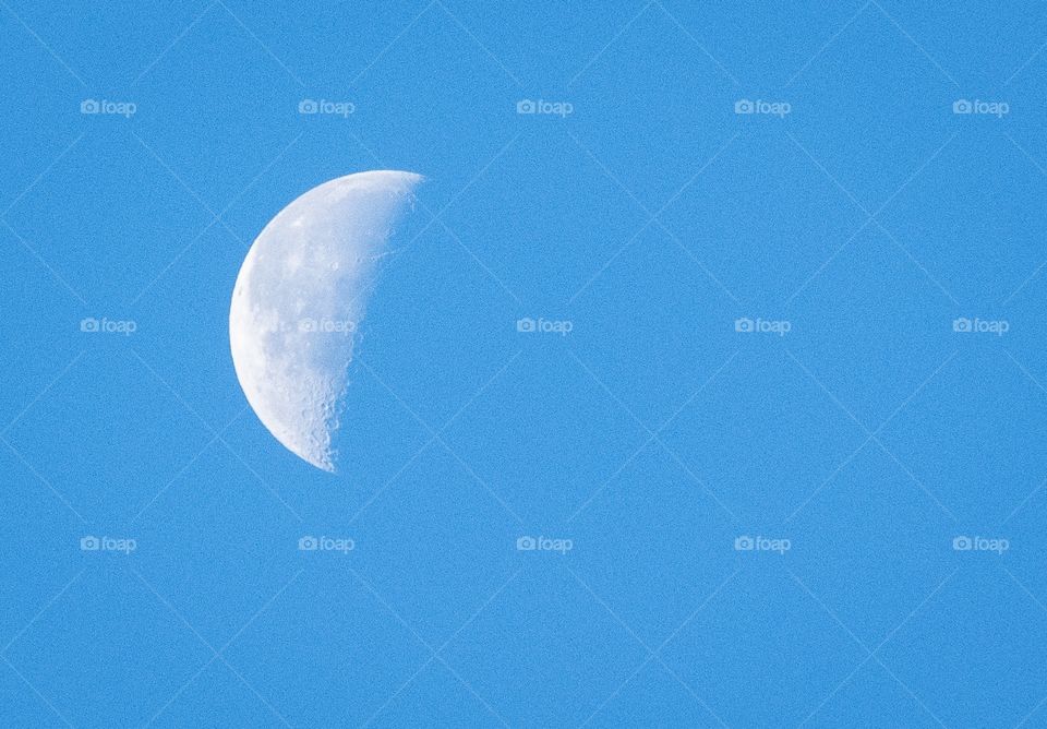 Half moon on the blue sky