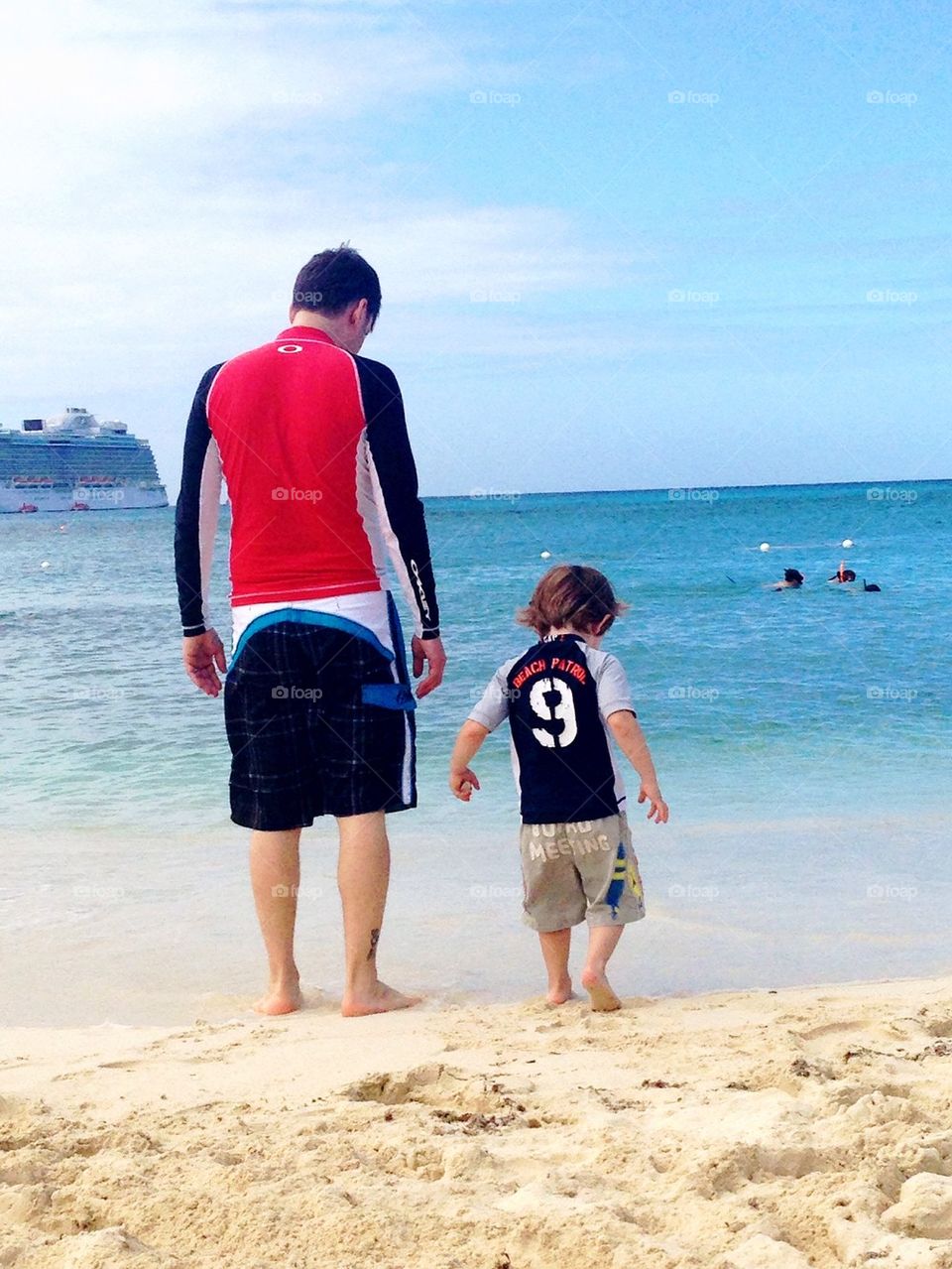 Father and son on a beach.