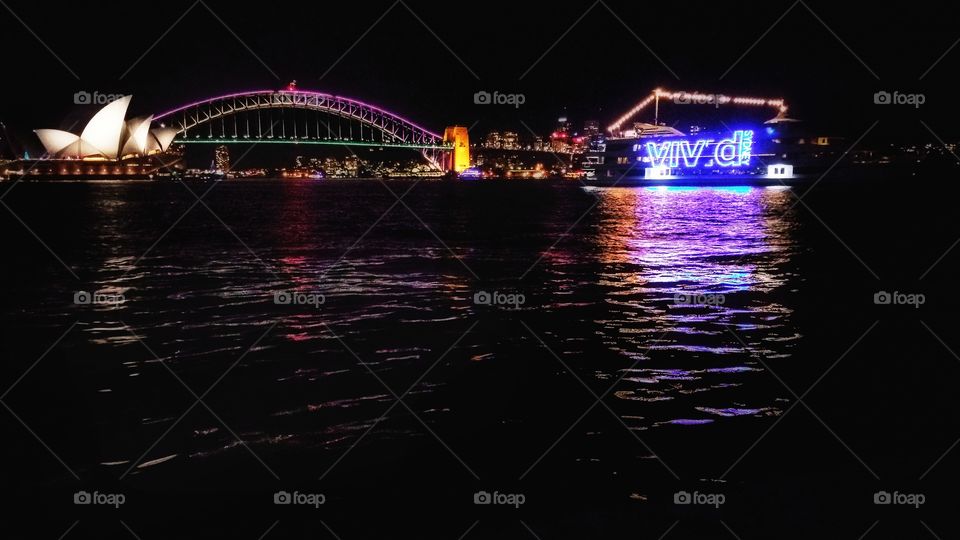 Nght image shot from the Sydney Harbor foreshore on 30th May, 2016 - The Vivid Sydney event. Featuring the famous Sydney Opera House and Harbour Bridge.