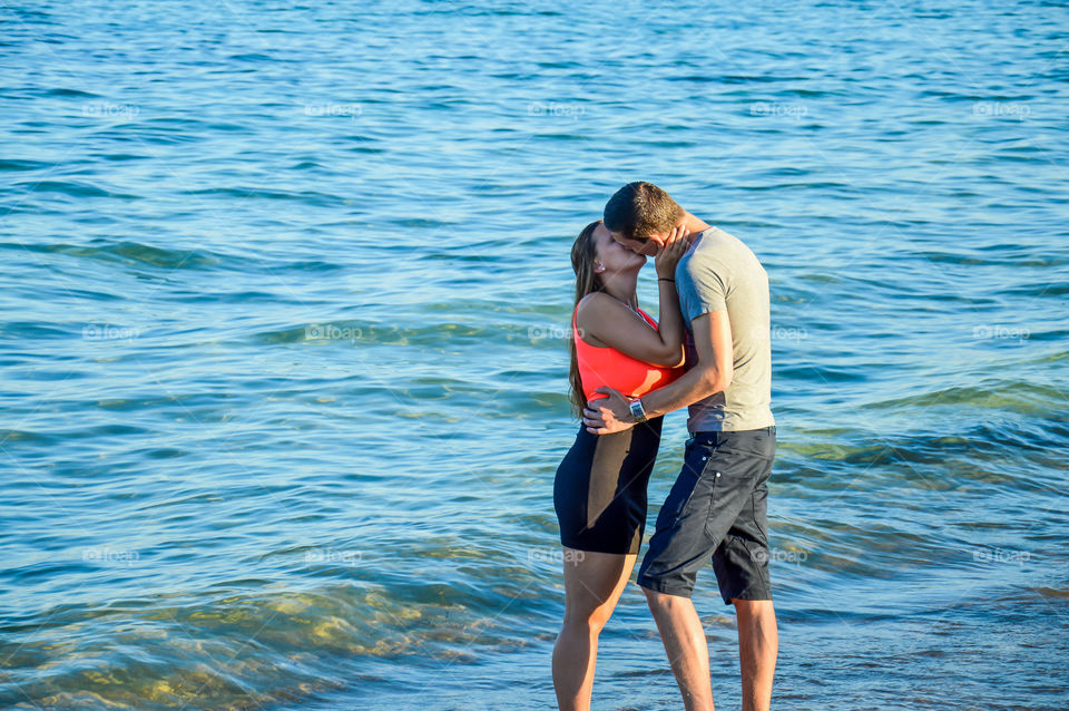 Lovely couple kissing. Lovely couple kissing at the beach