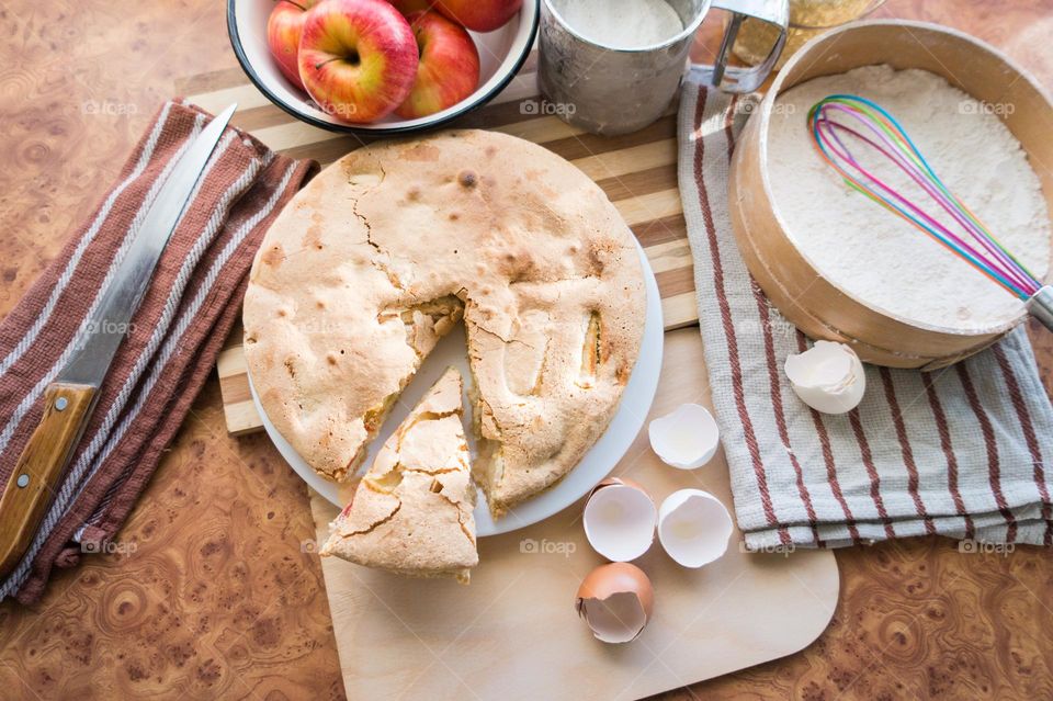 Making homemade puffed apple pie with eggs, sugar and flour.