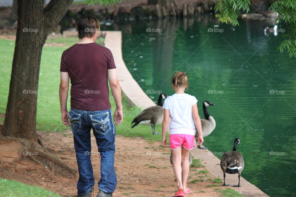 Daddy daughter walk. Daddy and his girl walking at the park