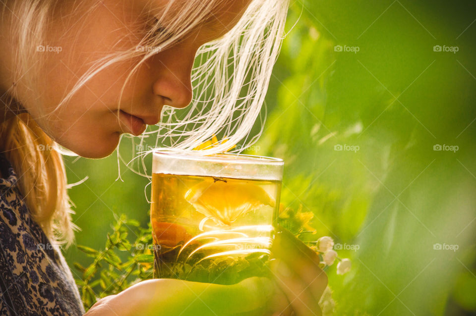 girl is drinking green tea with lemon