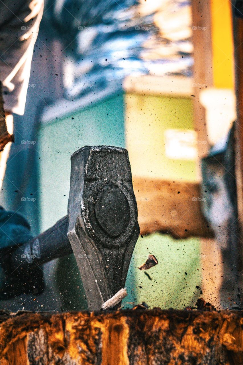 Axe slamming into stump.