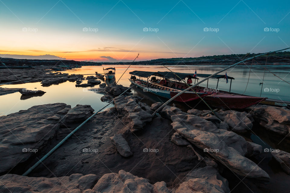 Sunset with boats at 3000 Bok in Ubon Ratchathani Thailand