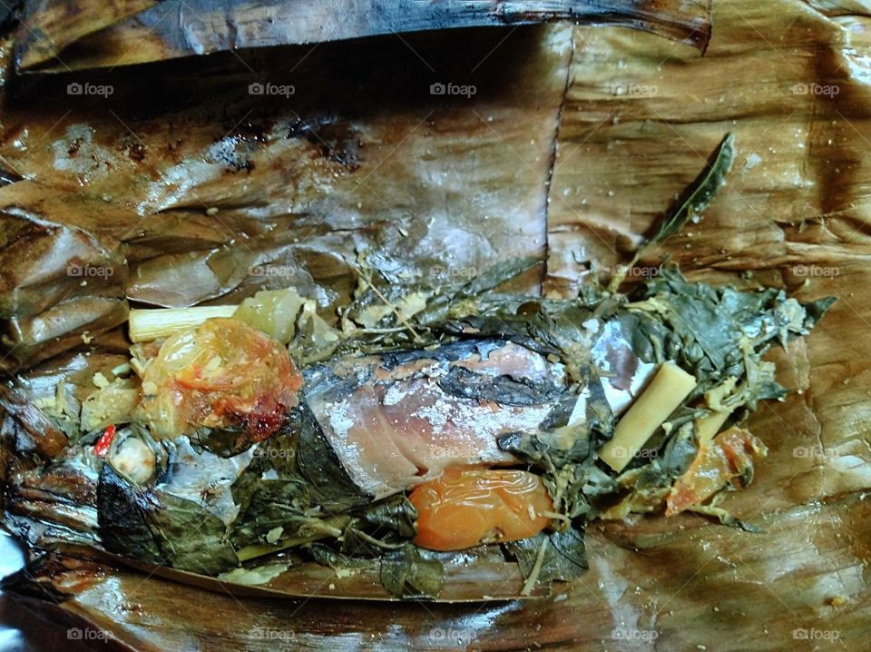 Steamed fish wrapped in leaves