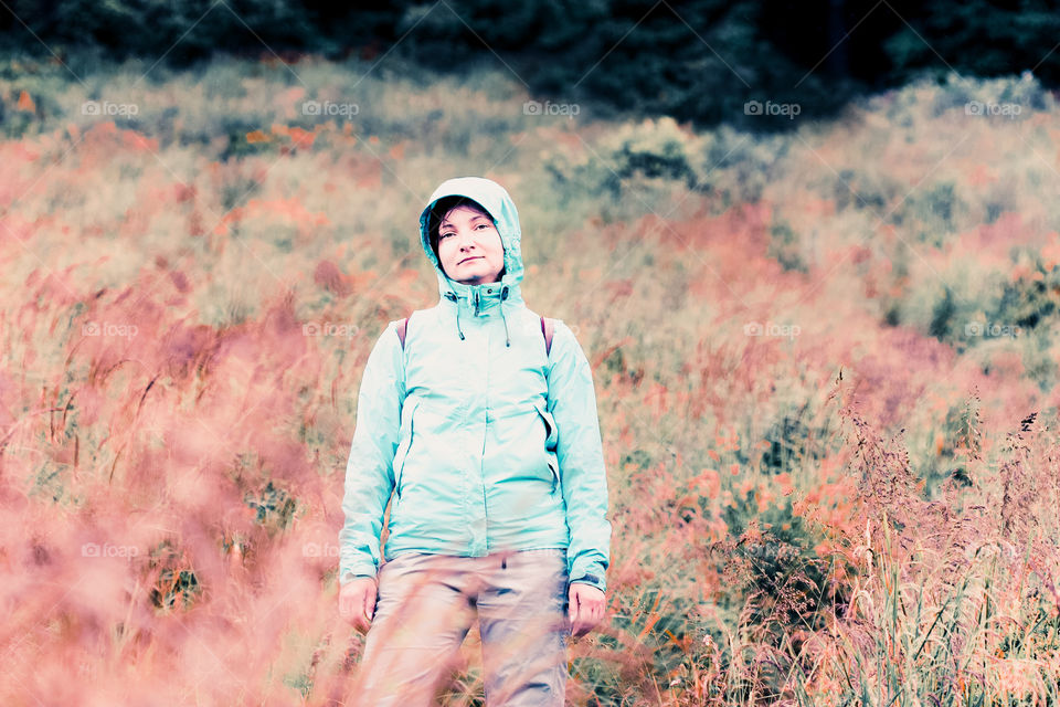 Woman standing on grassy slope